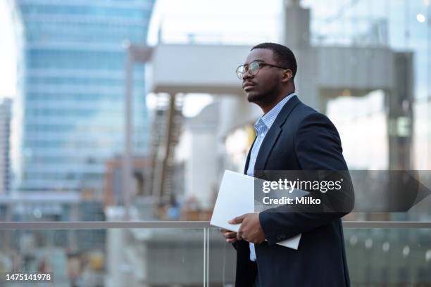 side view of young african american businessman in modern environment - man side view stock pictures, royalty-free photos & images