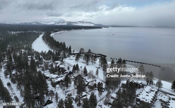 In an aerial view, snow covers the banks of Lake Tahoe on March 21, 2023 in South Lake Tahoe, California. As a 12th atmospheric river hits...