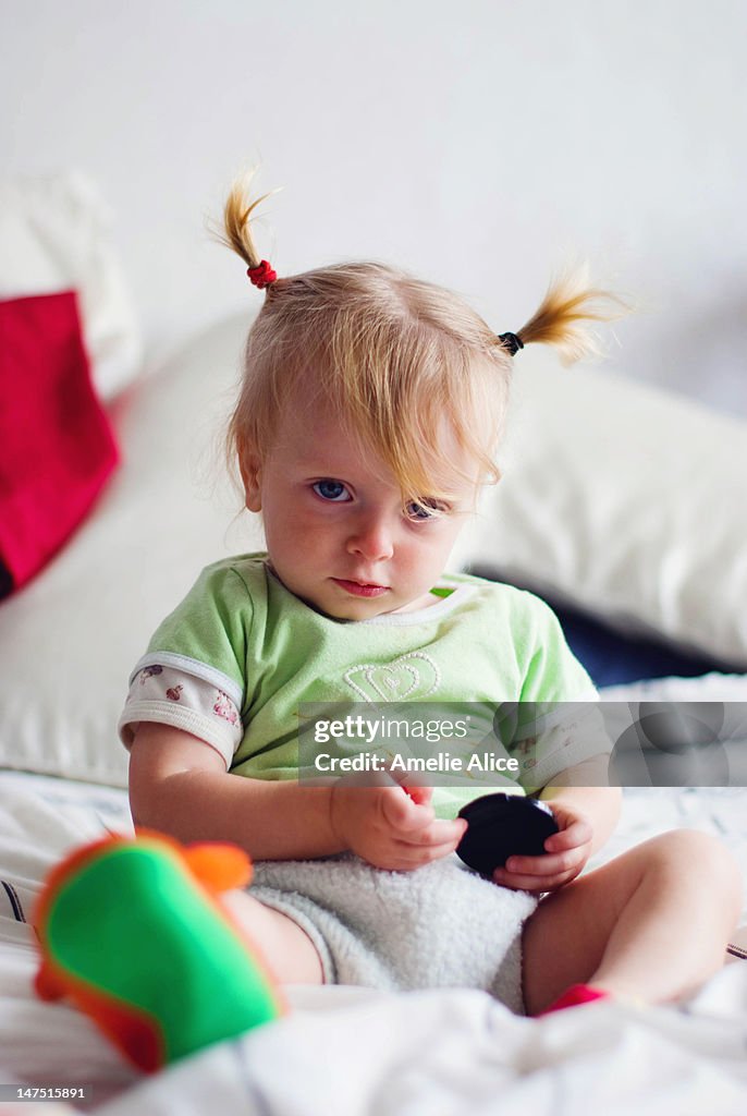 Baby girl playing on bed