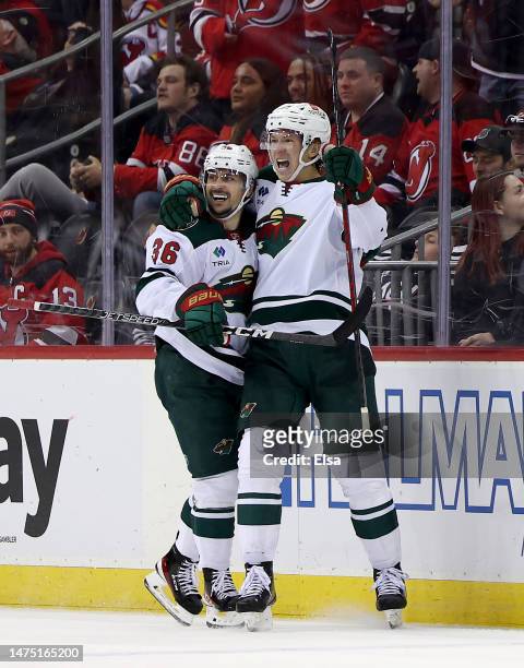 Matt Boldy of the Minnesota Wild celebrates his game winning goal with teammate Mats Zuccarello during the overtime period against the New Jersey...