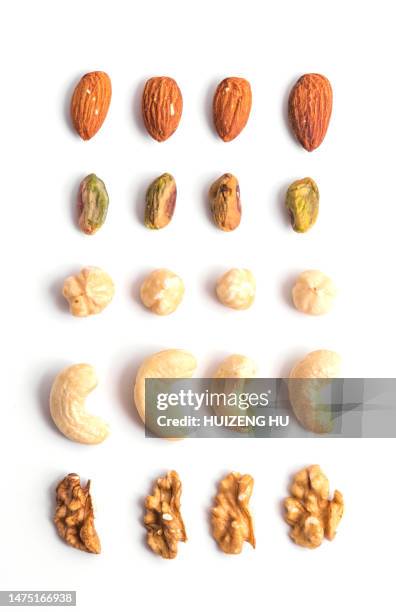 nuts close up isolated on white background. walnut, almond pistachio and cashew, healthy diet snack - macadamia nut 個照片及圖片檔