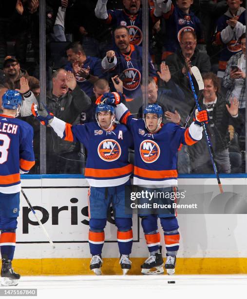 Cal Clutterbuck of the New York Islanders celebrates his second goal of the game in the third period against the Toronto Maple Leafs and is joined by...