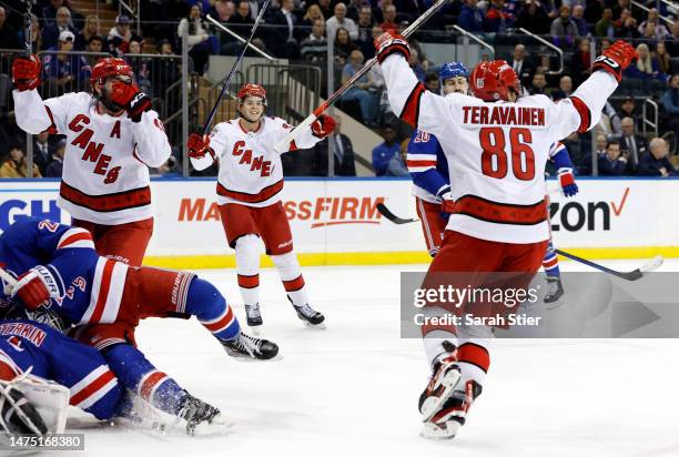 Jesperi Kotkaniemi reacts with Teuvo Teravainen of the Carolina Hurricanes after Teravainen's game-winning goal during the third period against the...