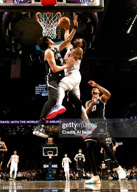 Donovan Mitchell of the Cleveland Cavaliers dunks against Yuta Watanabe of the Brooklyn Nets during their game at Barclays Center on March 21, 2023...