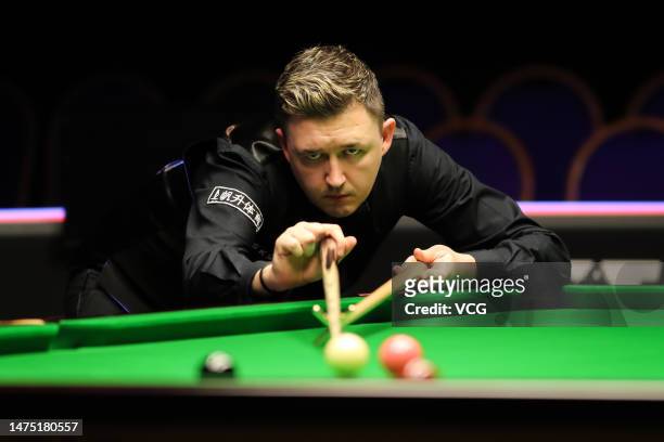 Kyren Wilson of England plays a shot in the fourth round match against John Higgins of Scotland on day 6 of 2023 WST Classic at the Morningside Arena...