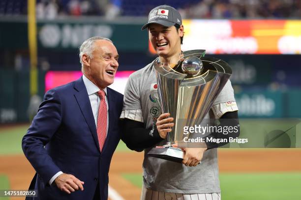 Shohei Ohtani of Team Japan is awarded the trophy by the Commissioner of Baseball Rob Manfred after defeating Team USA in the World Baseball Classic...