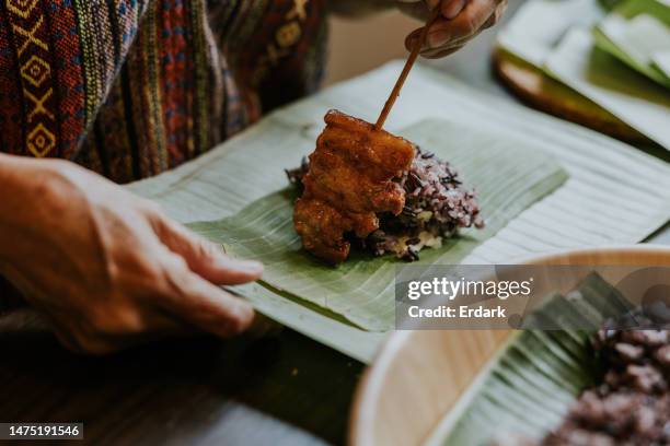 home cook product with grilled pork with sticky rice with banana leaf container. - thai food stock pictures, royalty-free photos & images