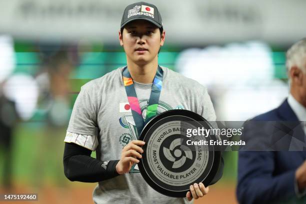 Shohei Ohtani of Team Japan poses for a photo with the MVP after defeating Team USA in the World Baseball Classic Championship at loanDepot park on...