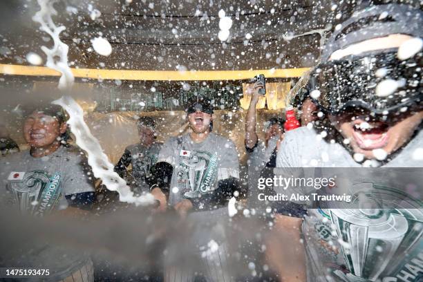 Kazuma Okamoto, Shohei Ohtani, and Munetaka Murakami of Team Japan celebrate in the clubhouse after defeating Team USA in the World Baseball Classic...