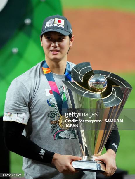 Shohei Ohtani of Team Japan holds the trophy after defeating Team USA 3-2 in the World Baseball Classic Championship at loanDepot park on March 21,...