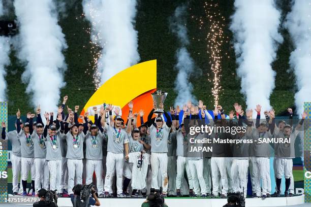 Shohei Ohtani of Team Japan lifts the trophy at the award ceremony after defeating Team USA 3-2 following the World Baseball Classic Championship at...