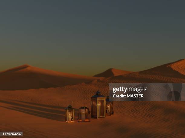 ramadan lanterns in desert at sunset - arab festival stock-fotos und bilder