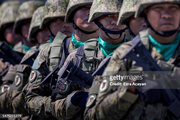 Philippine troops stand in formation during the 126th founding anniversary of the Philippine Army at Fort Bonifacio on March 22, 2023 in Taguig,...