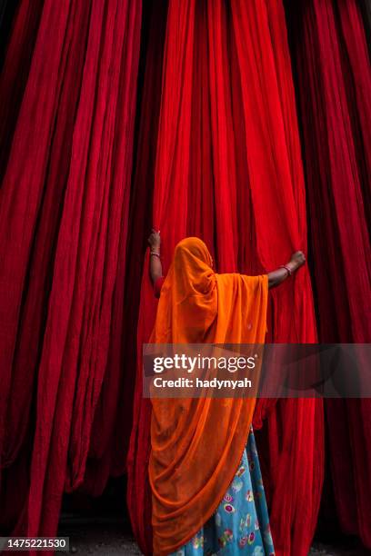 colors of india - woman checking dyed fabrics, rajasthan, india - indian textile stock pictures, royalty-free photos & images