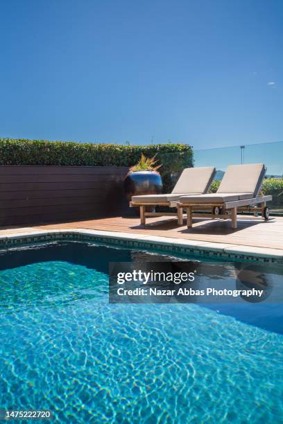 luxurious beach side villa with swimming pool. - new zealand beach house stock pictures, royalty-free photos & images