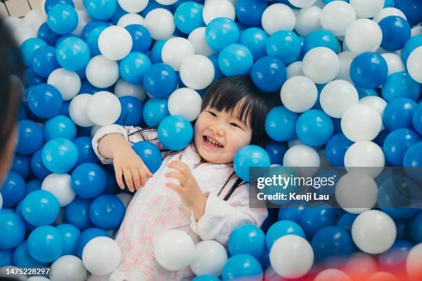 little asian cute girl play in ball bit in playhouse. - quarto de brincar imagens e fotografias de stock