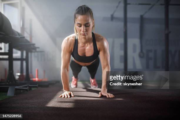 mulher atlética exercitando flexões em um clube de saúde. - treino com o peso corporal - fotografias e filmes do acervo