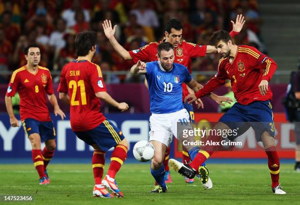 Antonio Cassano of Italy battles for the ball with Sergio Busquets , David Silva and Gerard Pique of Spain during the UEFA EURO 2012 final match...