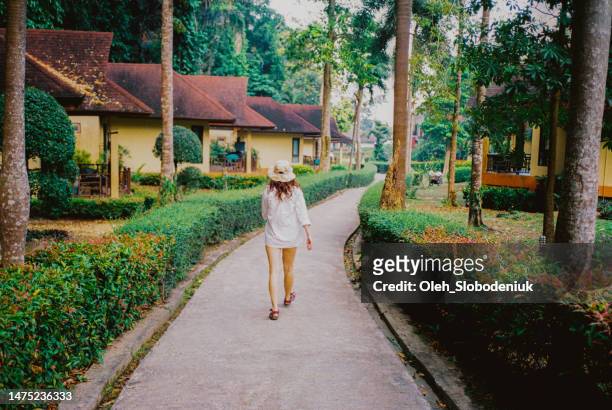 woman walking through the jungles  in beach resort - pacific rim film stock pictures, royalty-free photos & images