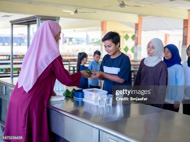 woman serving lunch in school cafetaria - canteen stock pictures, royalty-free photos & images