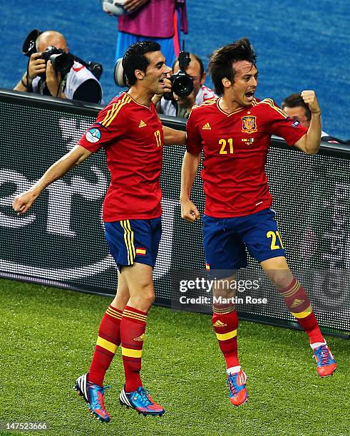David Silva of Spain celebrates with team-mate Alvaro Arbeloa after scoring the opening goal during the UEFA EURO 2012 final match between Spain and...