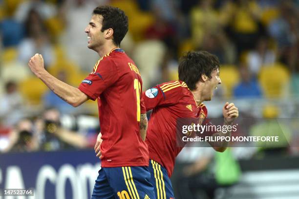 Spanish midfielder David Silva celebrates with midfielder Cesc Fabregas after scoring a goal during the Euro 2012 football championships final match...