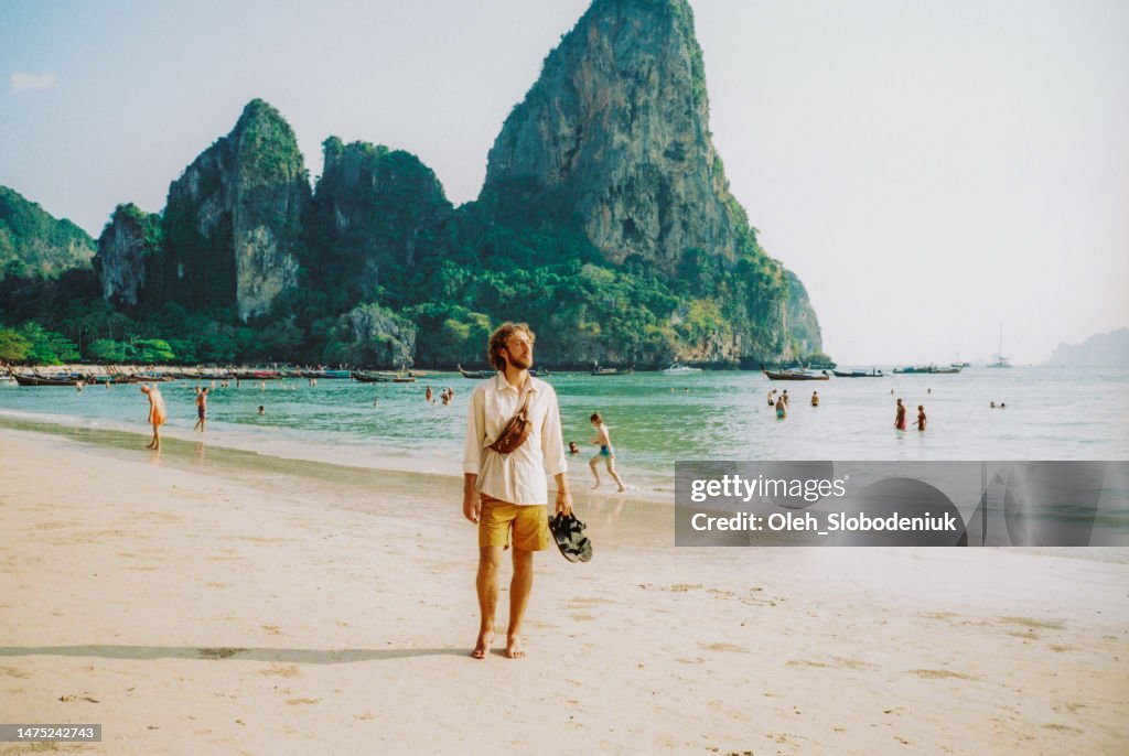 Man walking on Railey beach and looking at stunning scenery