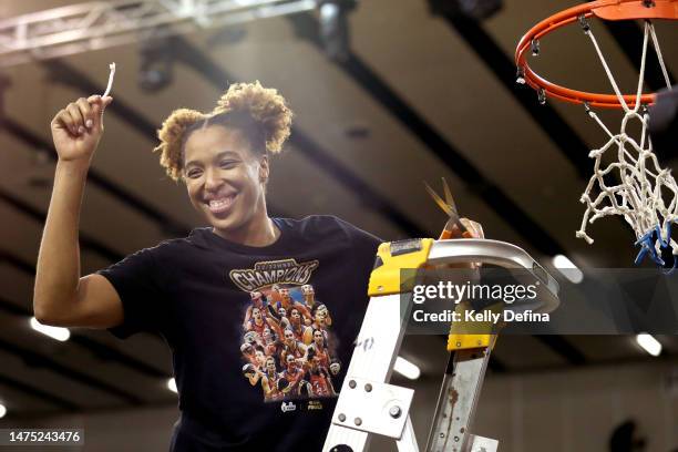 Tianna Hawkins of the Fire cuts the net after winning the WNBL Championship during games two of the WNBL Grand Final series between Southside Flyers...