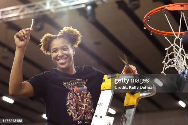 Tianna Hawkins of the Fire cuts the net after winning the WNBL Championship during games two of the WNBL Grand Final series between Southside Flyers...