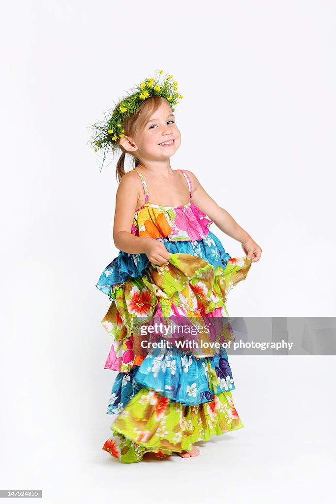 3 years old girl in bright summer dress dancing