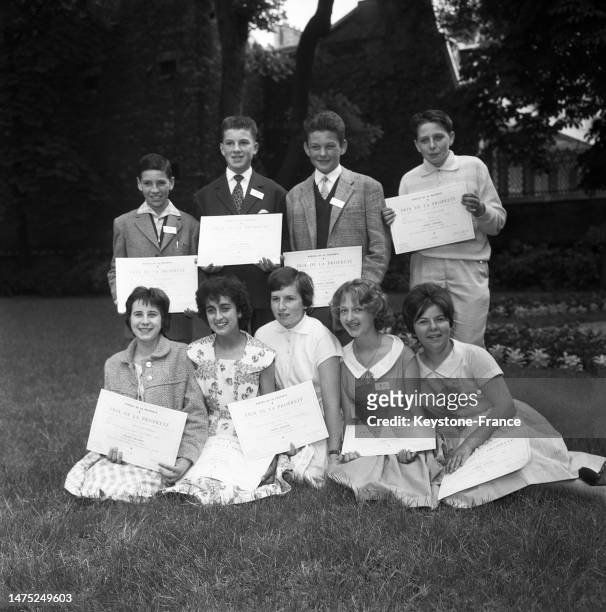 Les lauréats du 'Concours de la Propreté' posant avec leurs diplôme dans le jardin du ministère de l'Education à Paris, le 6 juillet 1960.