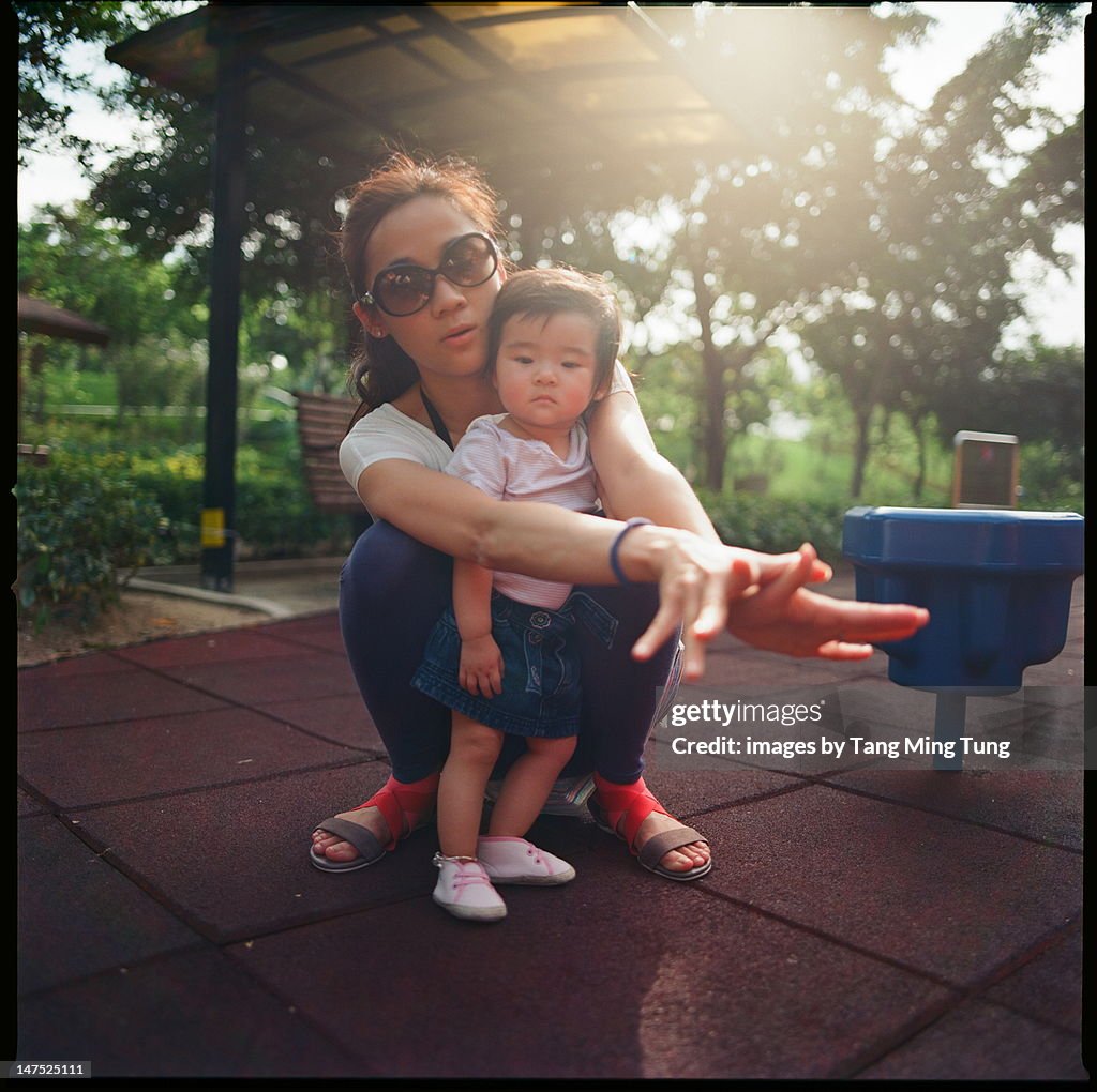 Beautiful mom playing with baby girl