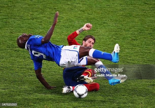 Sergio Ramos of Spain slides in to tackle Mario Balotelli of Italy during the UEFA EURO 2012 final match between Spain and Italy at the Olympic...