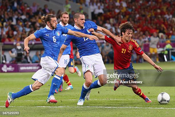 Federico Balzaretti and Leonardo Bonucci of Italy challenge David Silva of Spain during the UEFA EURO 2012 final match between Spain and Italy at the...