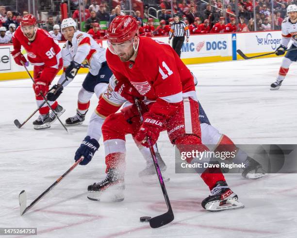 Filip Zadina of the Detroit Red Wings protects the puck from against the Florida Panthers during the third period of an NHL game at Little Caesars...