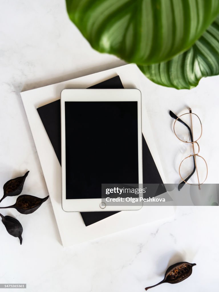 Flat lay of white tablet with screen mock up