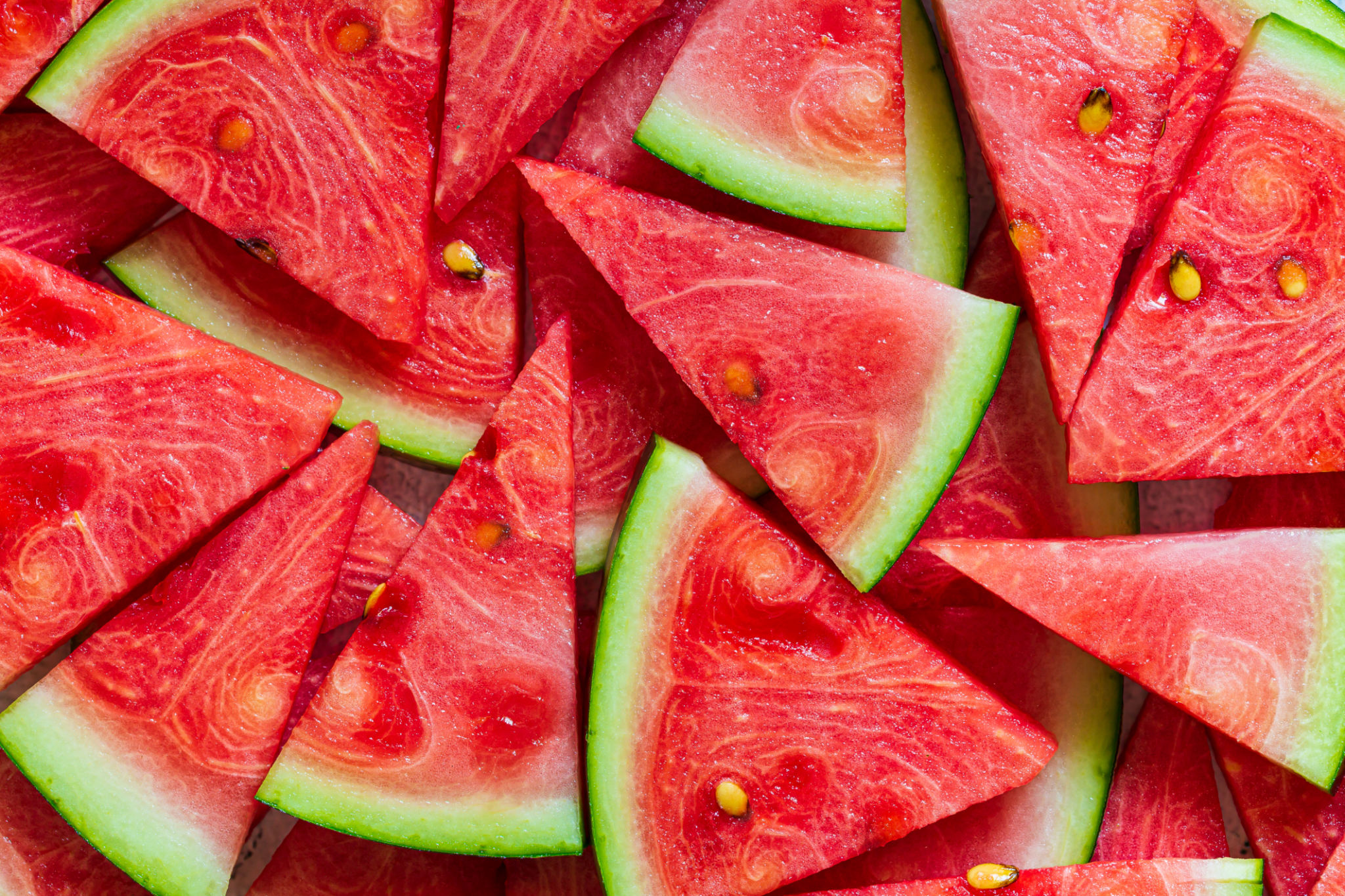 macro sliced watermelon,Red watermelon triangular piece on white blackground macro sliced watermelon,Red watermelon triangular piece on white blackground
