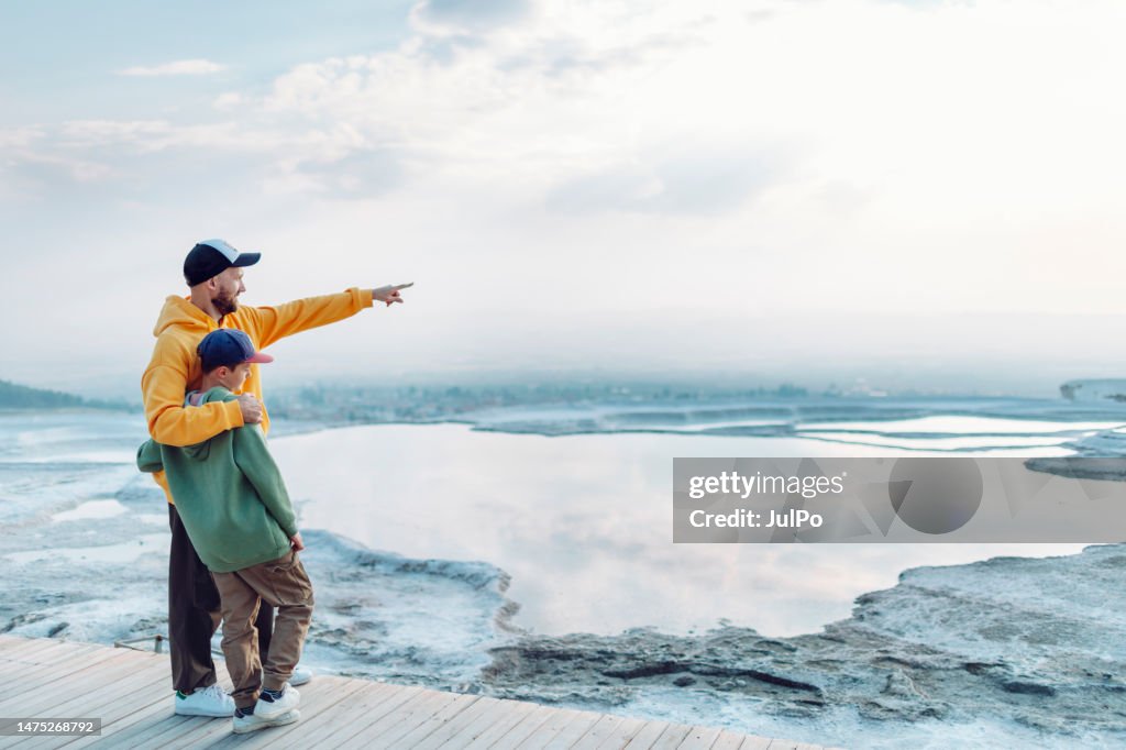 Father and son looking at view at Pamukkale