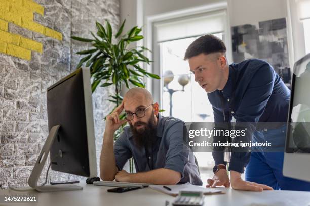 Computer Work Men Two Young Men Using A Computer For Work In The Office High-Res Stock ...