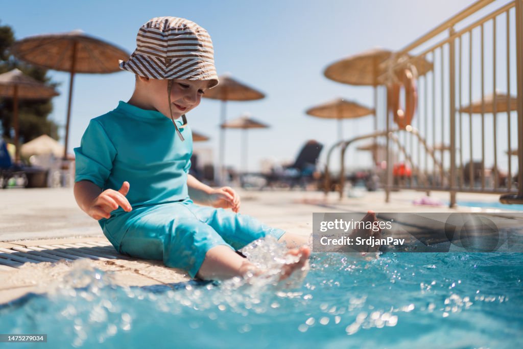 Toddler boy enjoying a day at the swimming pool