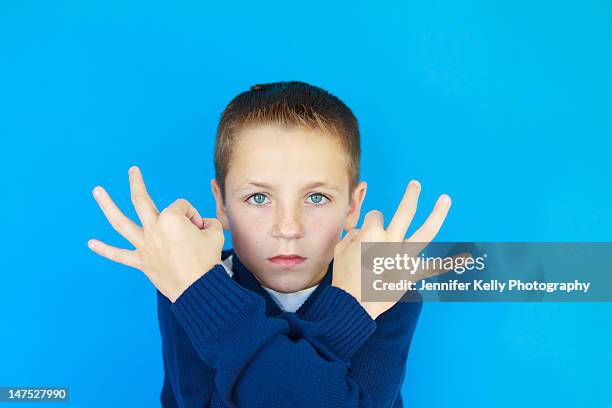 blonde blue eyed boy showing 3 pointer symbol - jennifer kelly stock pictures, royalty-free photos & images