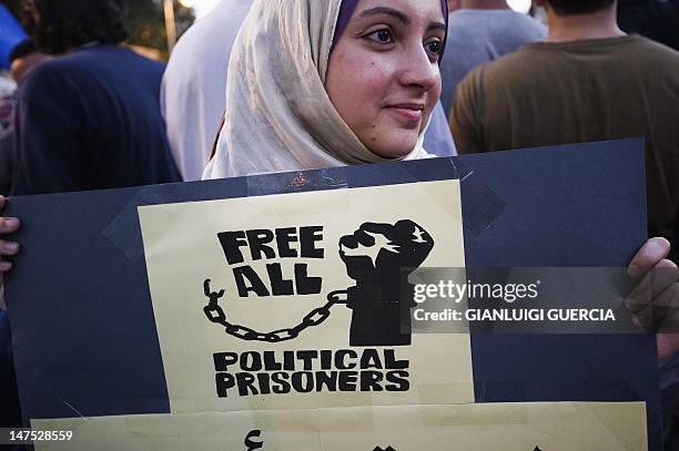 Woman demonstrates with hundreds on July 01, 2012 in front of the presidential palace in Cairo to demand the realease of political prisoners arrested...