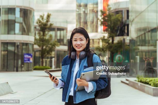 porträt einer schönen asiatin - student girl using laptop computer and smart phone stock-fotos und bilder