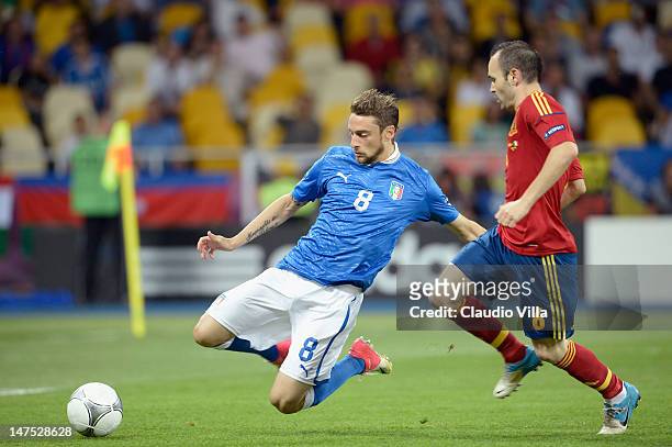 Claudio Marchisio of Italy battles for the ball with Andres Iniesta of Spain during the UEFA EURO 2012 final match between Spain and Italy at the...