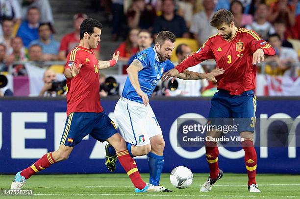 Antonio Cassano of Italy in action against Sergio Busquets and Gerard Pique of Spain during the UEFA EURO 2012 final match between Spain and Italy at...