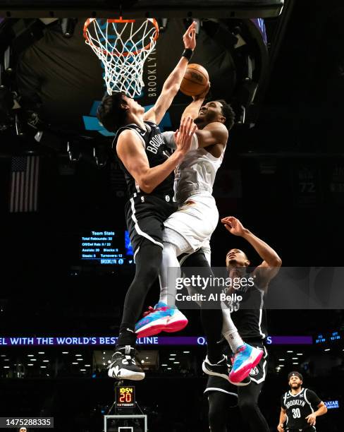 Donovan Mitchell of the Cleveland Cavaliers dunks against Yuta Watanabe of the Brooklyn Nets during their game at Barclays Center on March 21, 2023...