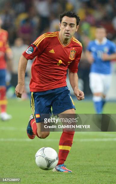 Spanish midfielder Xavi Hernandez runs with the ball during the Euro 2012 football championships final match Spain vs Italy on July 1, 2012 at the...