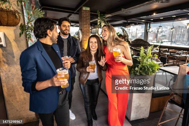 coworkers talking and drinking in the rooftop restaurant - entering restaurant stock pictures, royalty-free photos & images