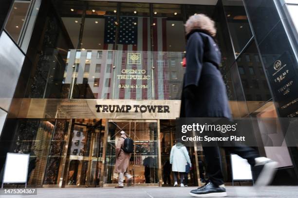 People walk by Trump Tower in Manhattan as the nation waits for the possibility of an indictment against former president Donald Trump by the...