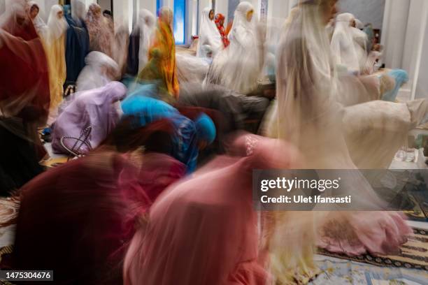 Indonesian Muslims perform Tarawih prayers to mark the start of the holy month of Ramadan at the Sheikh Zayed Solo Grand Mosque on March 22, 2023 in...